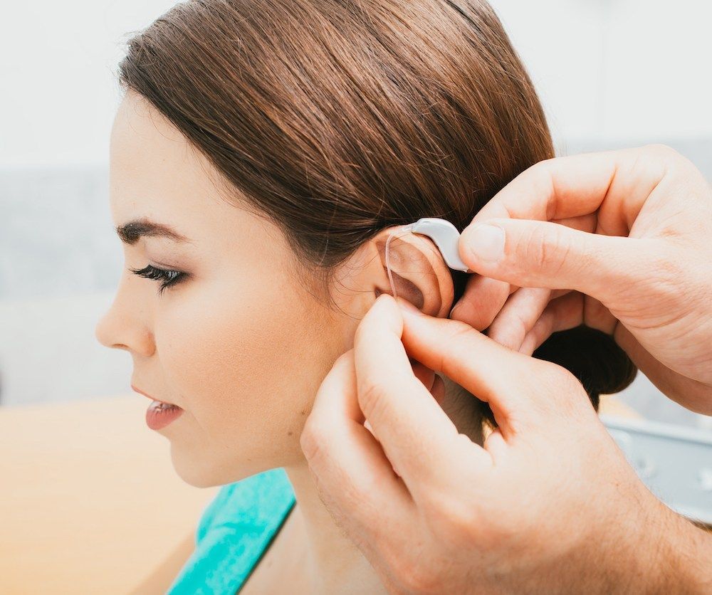 woman getting a new hearing aid