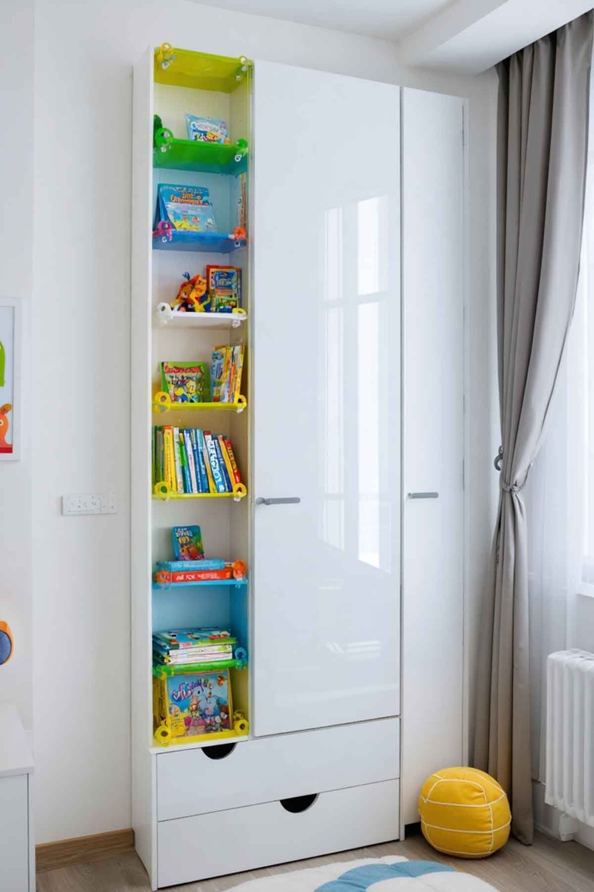 A white wardrobe with drawers and shelves in a child 's room.