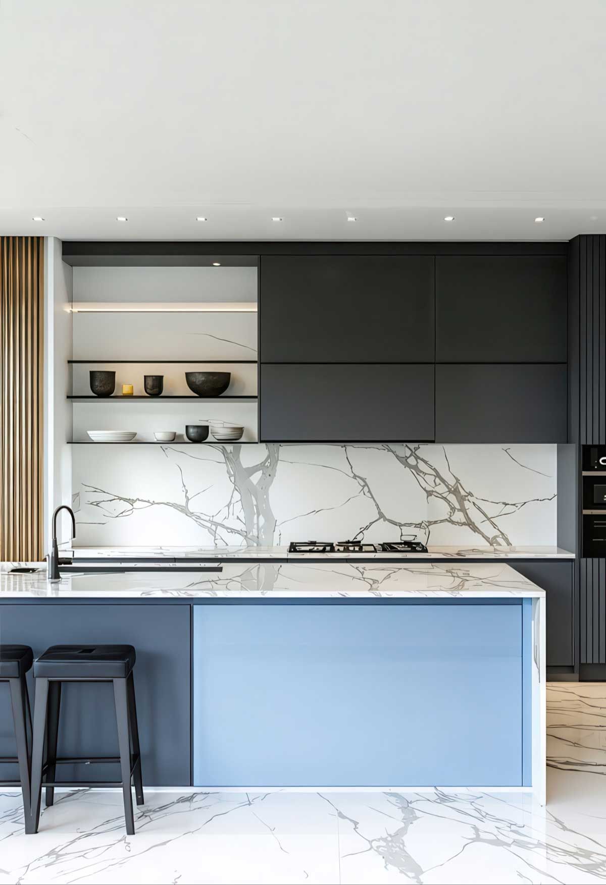 A kitchen with a two tone blue island , black cabinets , and marble counter tops.