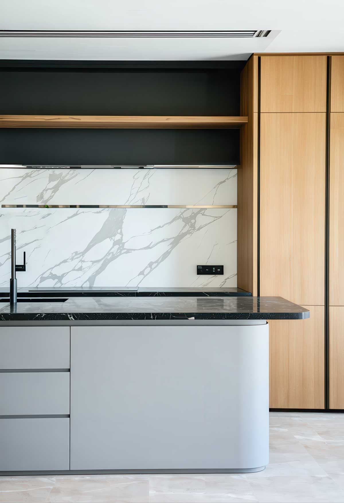 A kitchen with a sink , marble counter top , and wooden cabinets.