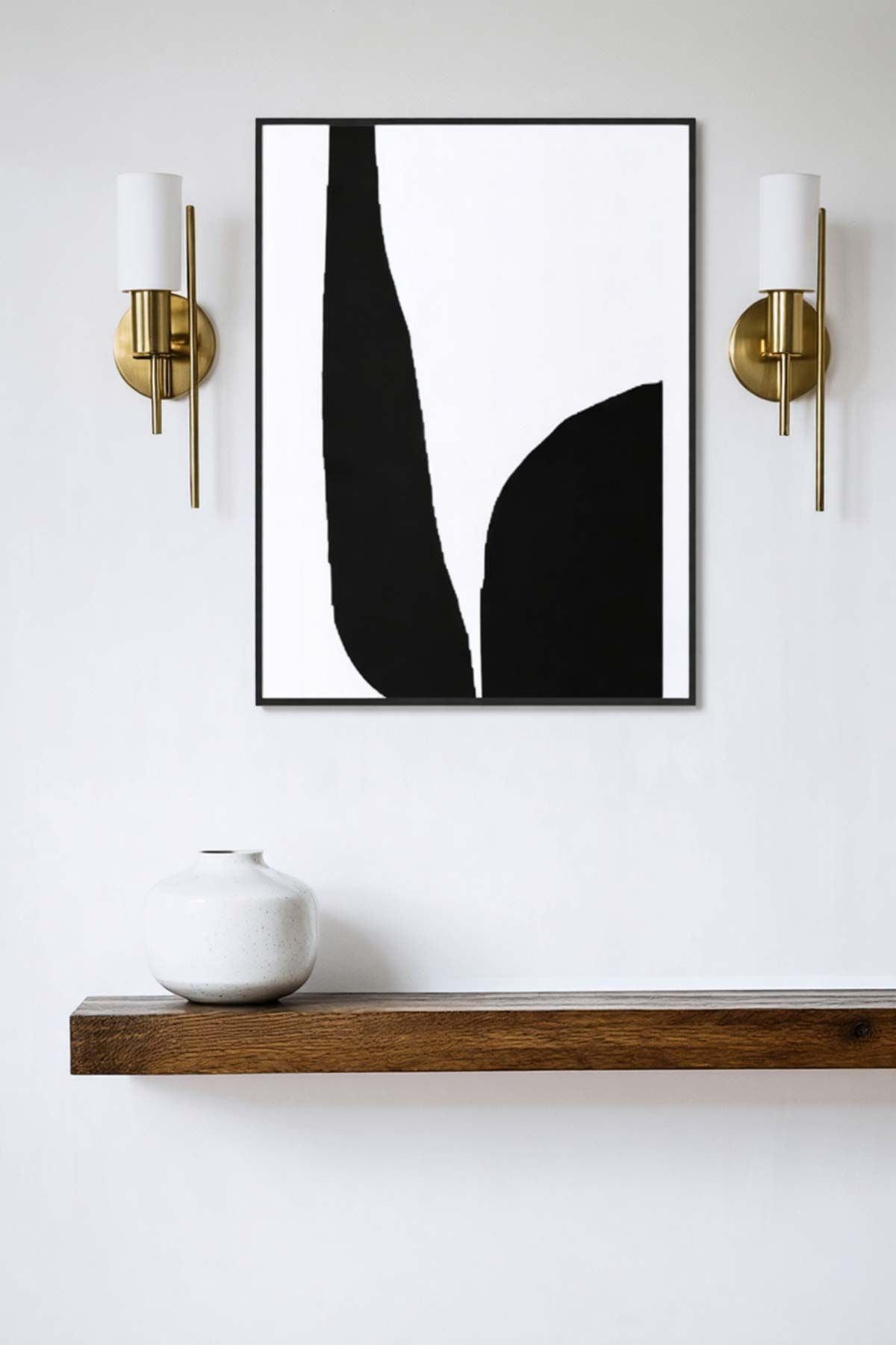 A black and white painting is hanging on a wall above a wooden shelf.