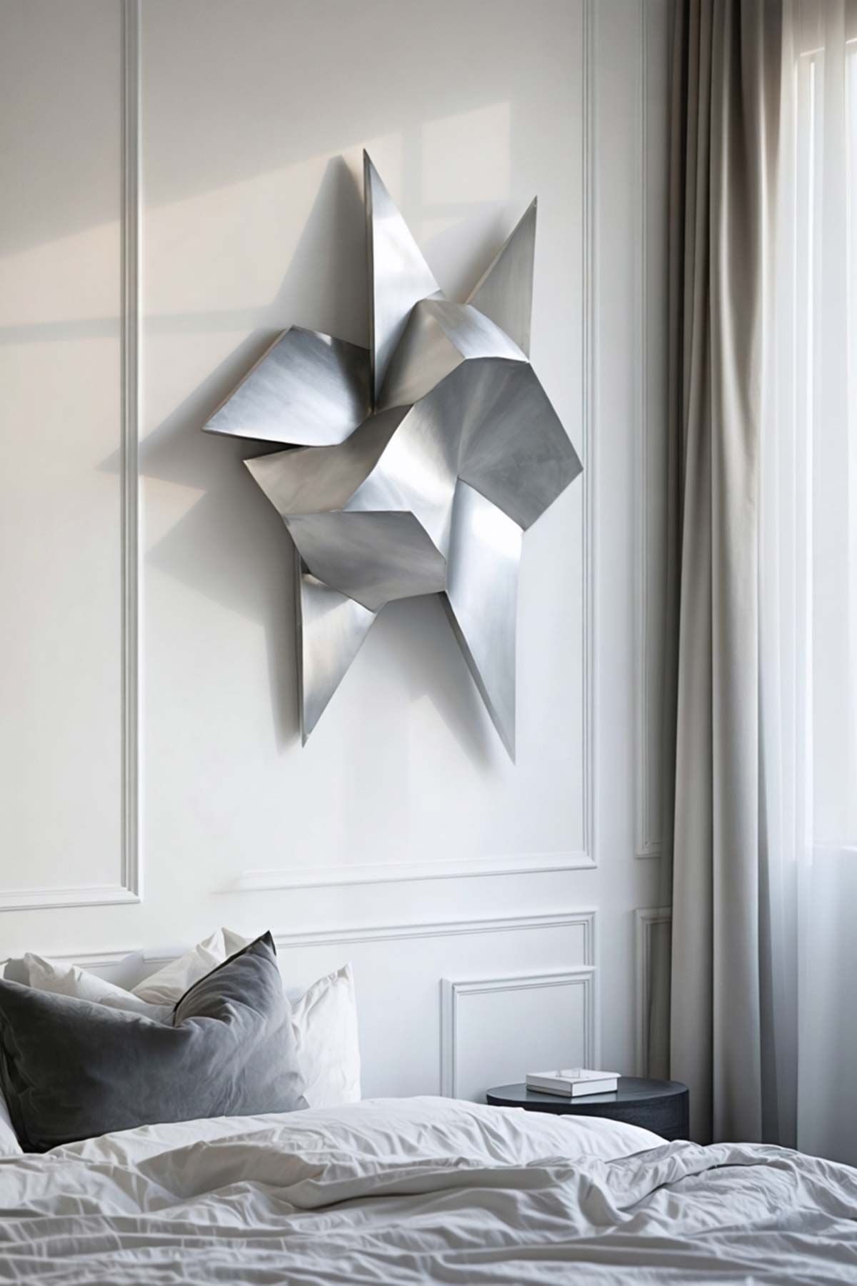 A bedroom with a bed and a sculpture on the wall above it.