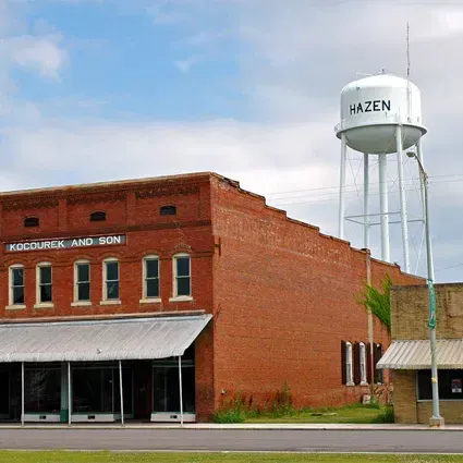 A brick building with a water tower that says hazen on it