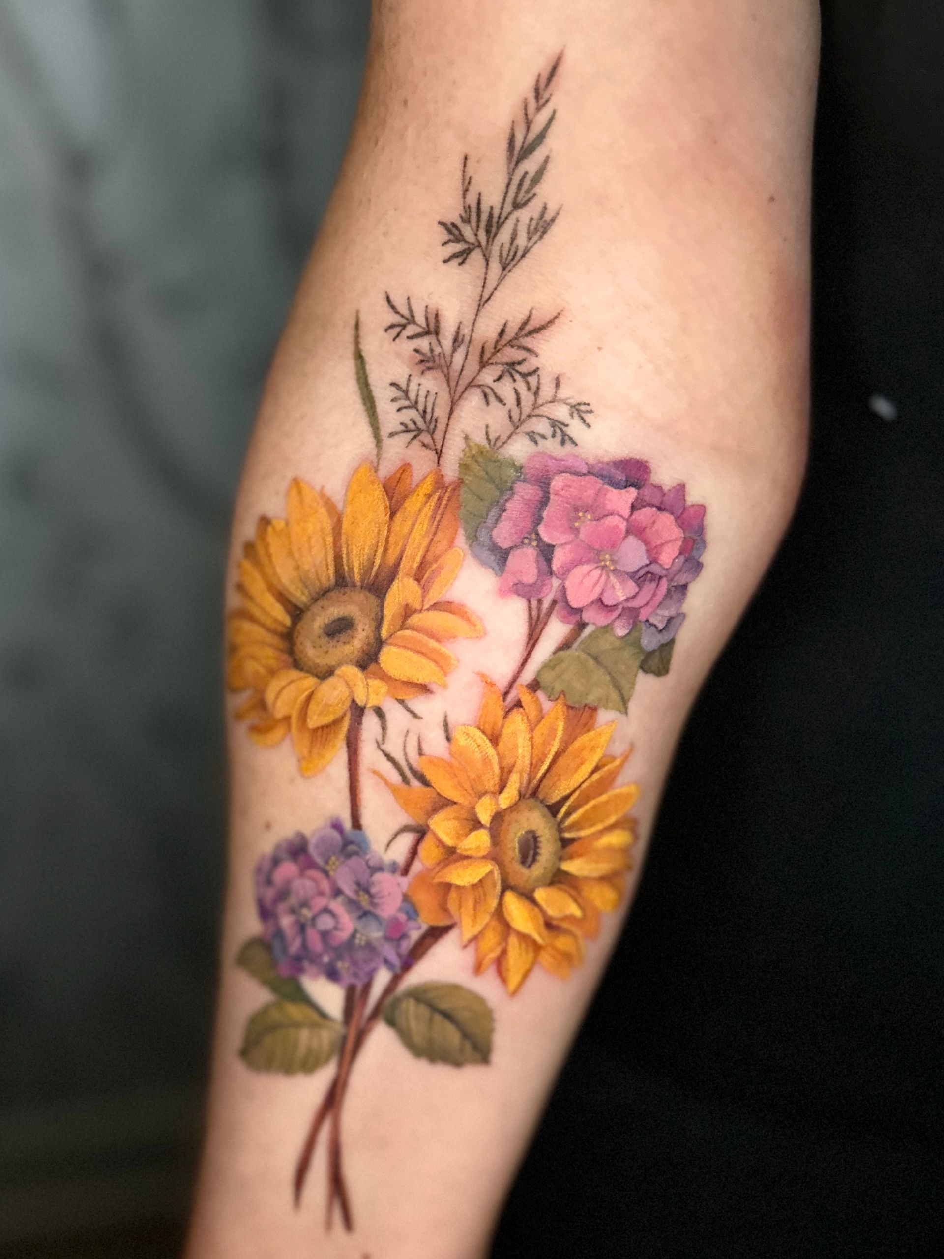 A woman has a tattoo of swallow with floral on her back