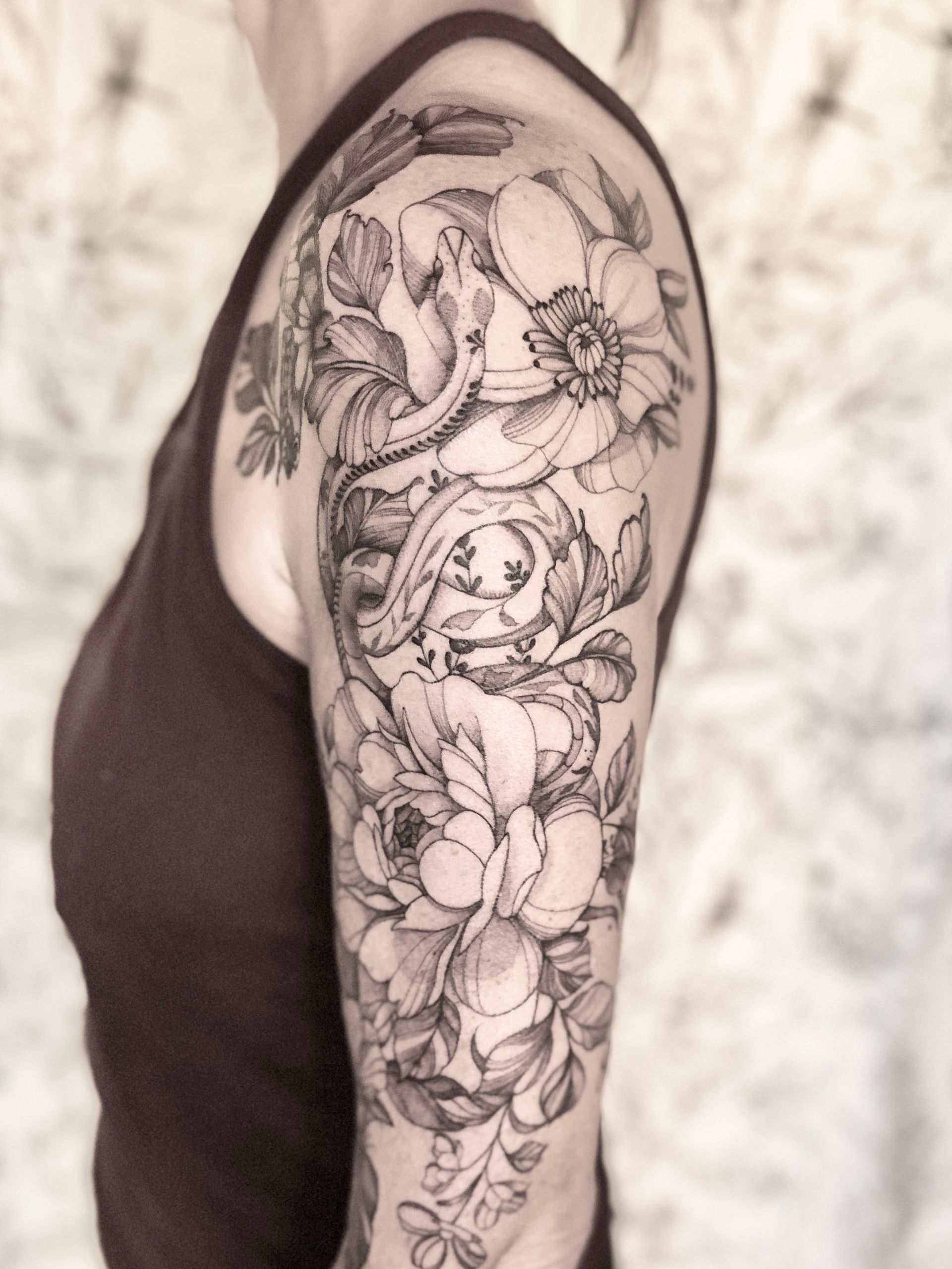 A woman has a tattoo of flowers on her arm