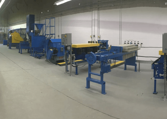 a row of blue and yellow machinery in a factory
