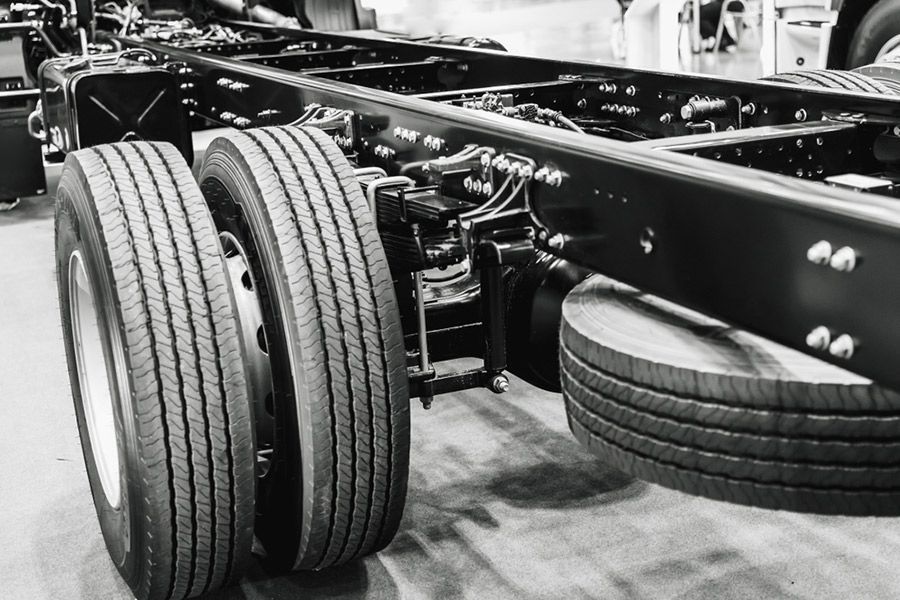 A Black and White Photo of A Truck's Tires and Frame — Al's Mechanical & 4WD Grafton Repairs in Grafton, NSW