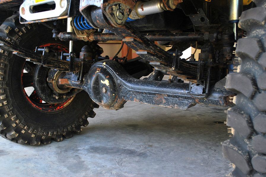 A Close-up Of the Underside of A Truck with A Large Tire — Al's Mechanical & 4WD Grafton Repairs in Grafton, NSW