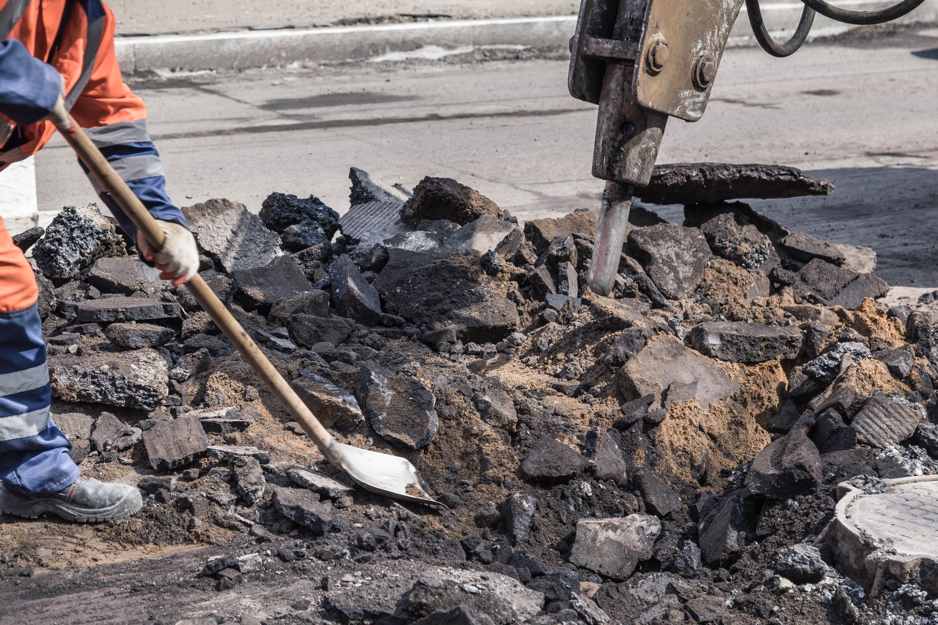 A man is using a shovel to dig a hole in the ground.