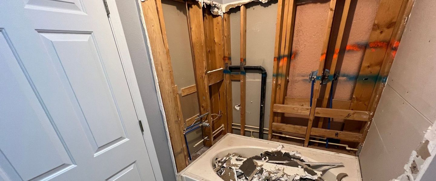 A bathroom with a bathtub that is being remodeled.