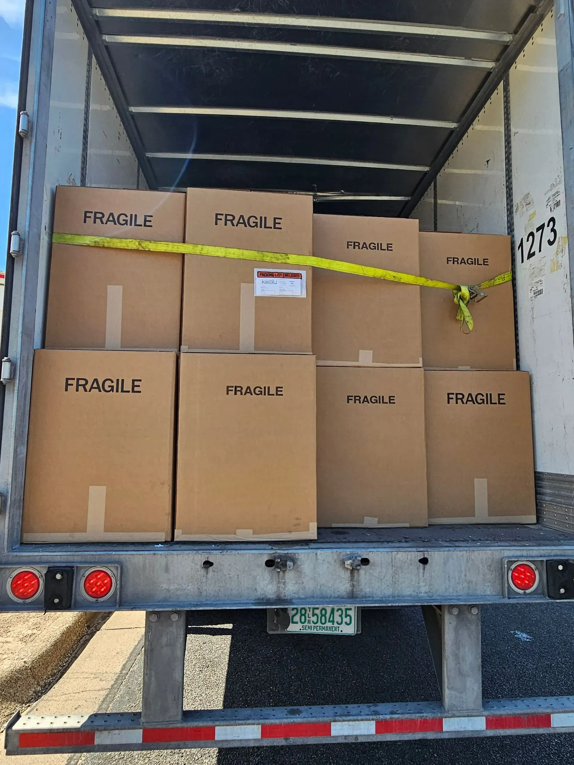The back of a truck filled with fragile boxes