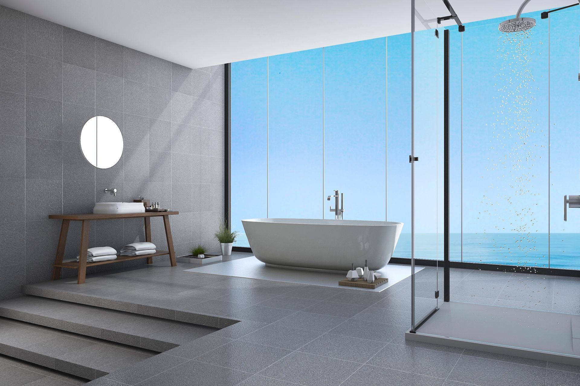 Un baño con bañera y ducha con vista al mar.
