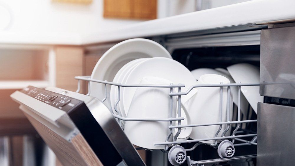 Home Cleaners — Open Dishwasher With Clean Dishes in Wilmington, NC