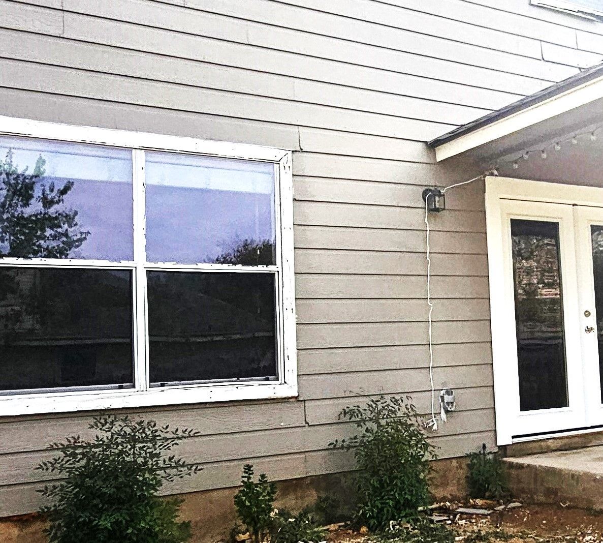 A house with a large window and a white door