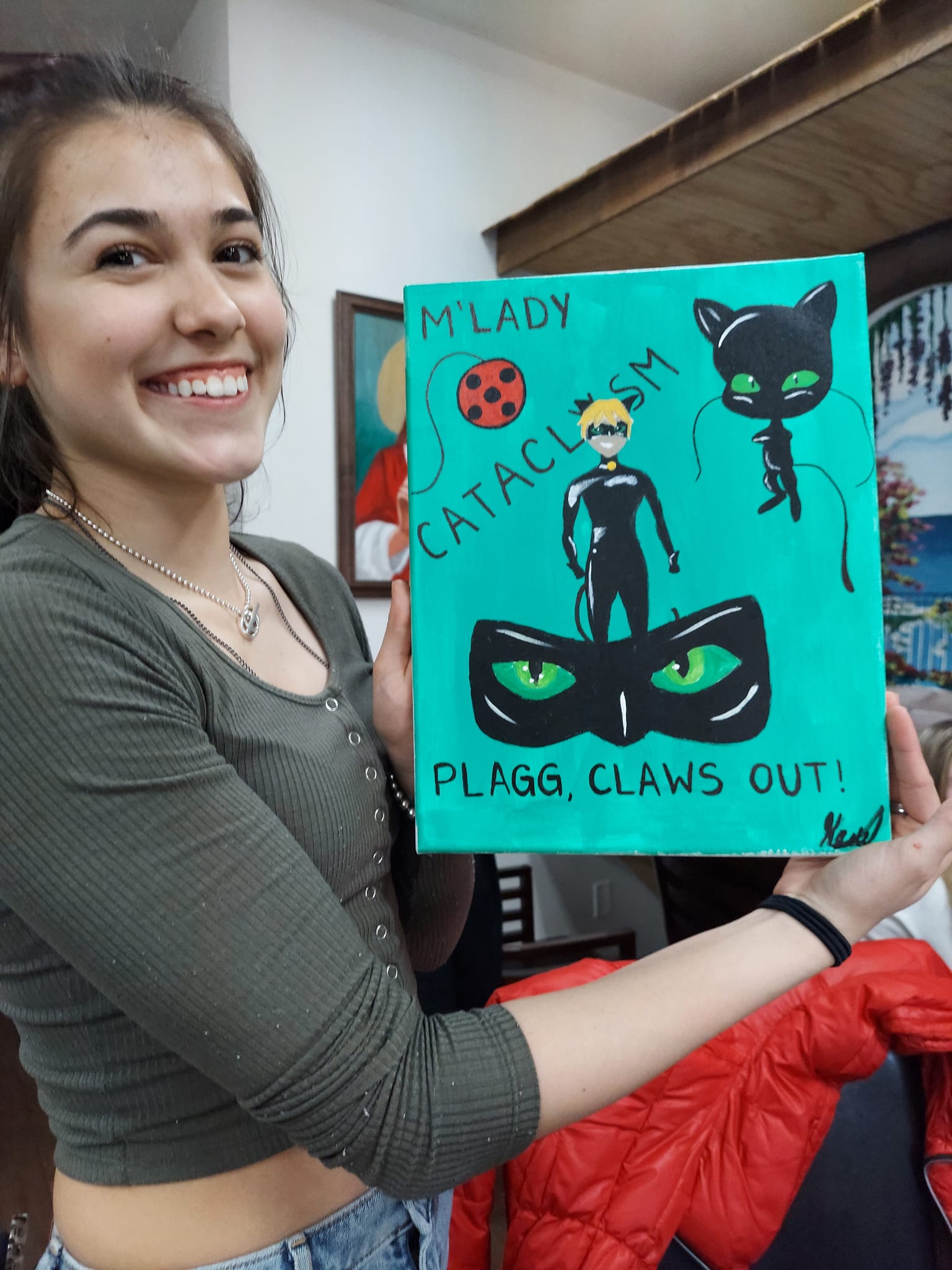 A woman is holding a painting that says m lady cataclysm