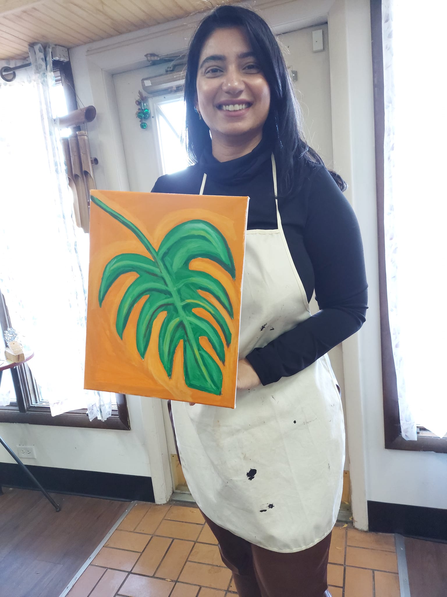 girl handling leaf painting