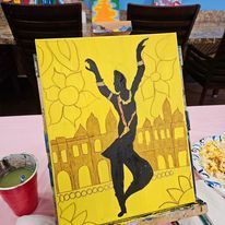 A painting of a woman dancing on a yellow background is on a table.