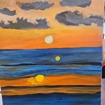 A painting of a sunset over the ocean on a canvas.