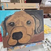 A painting of a dog sitting on top of an easel on a table.