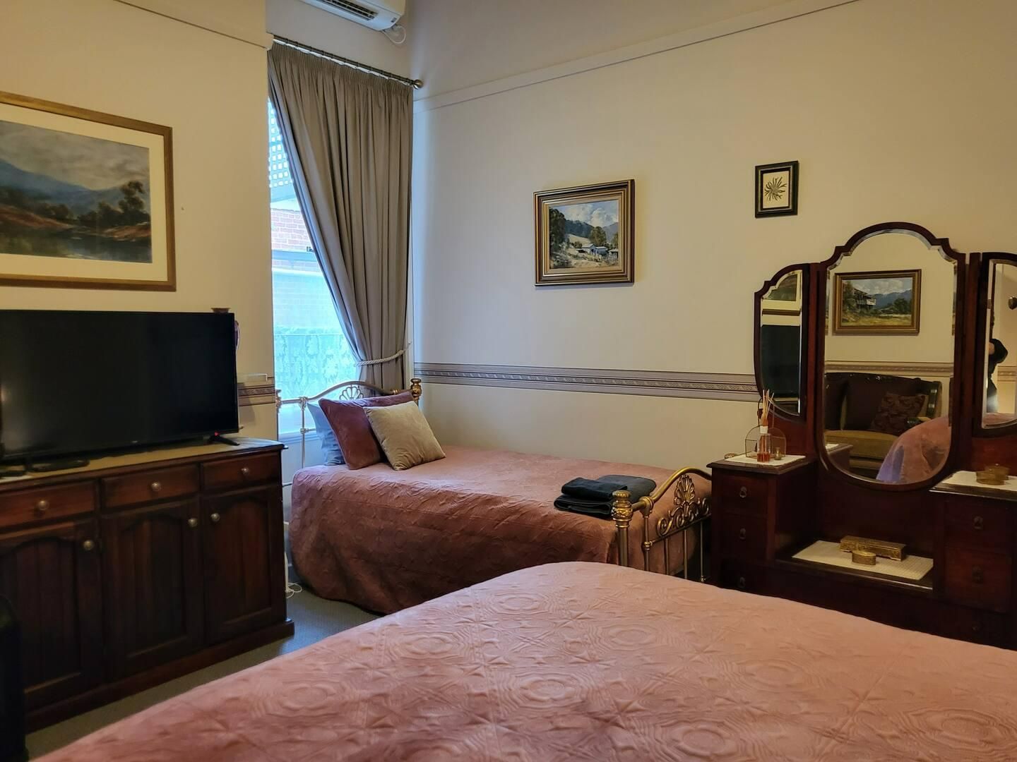 A Bedroom With Two Beds, Television and a Mirror — Accommodation in Forbes, NSW