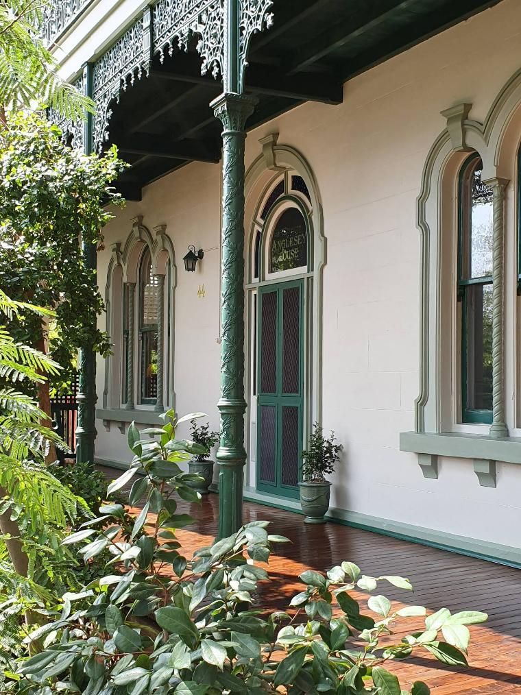 A White House With a Green Themed Door And Small Plants in Front of it — Accommodation in Forbes, NSW