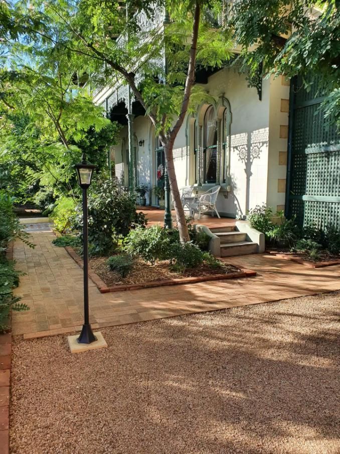 A Brick Walkway Leading To The Front Of A House — Accommodation in Forbes, NSW