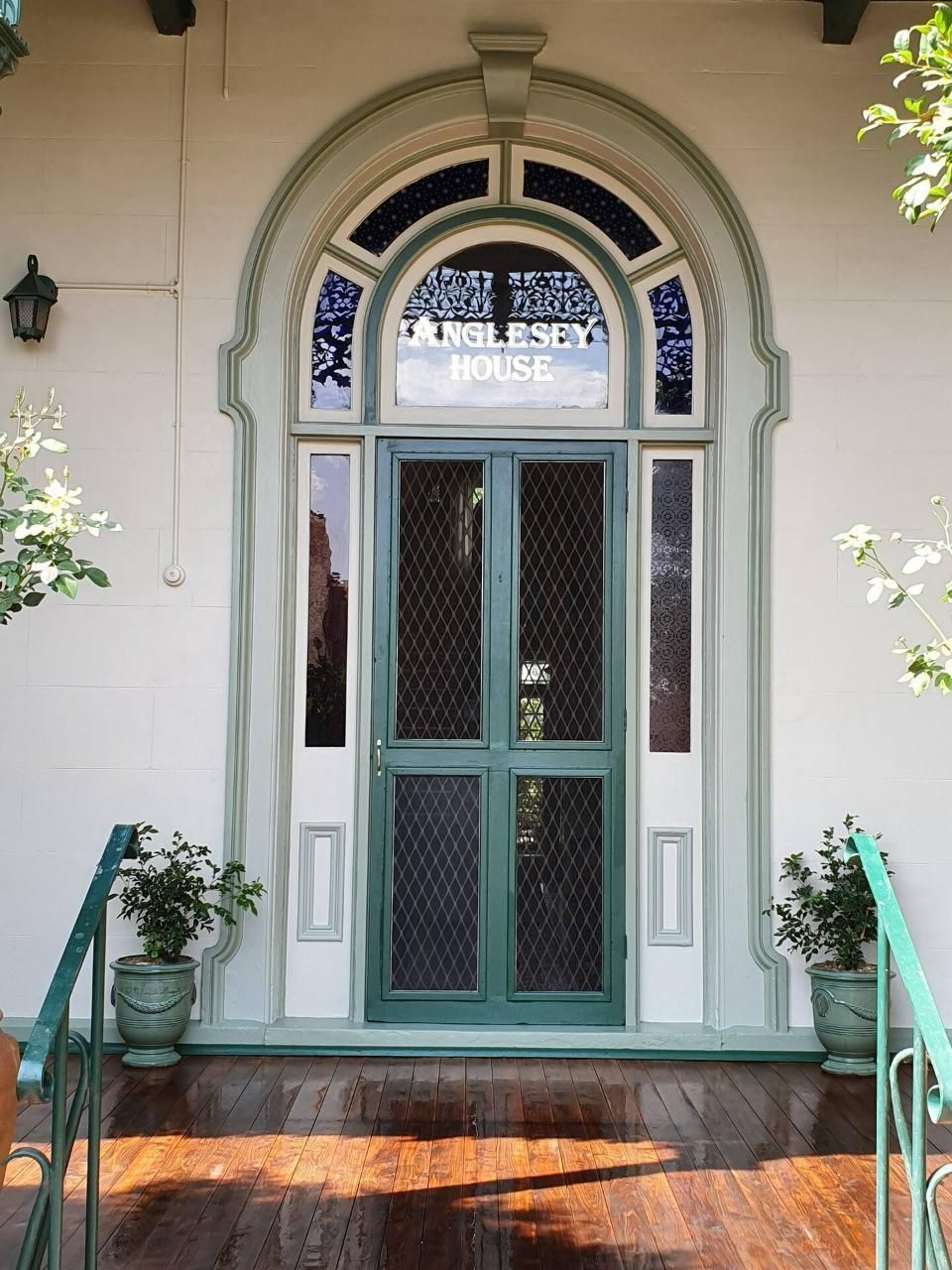 Closed Door With Small Plants on Either Side — Accommodation in Forbes, NSW