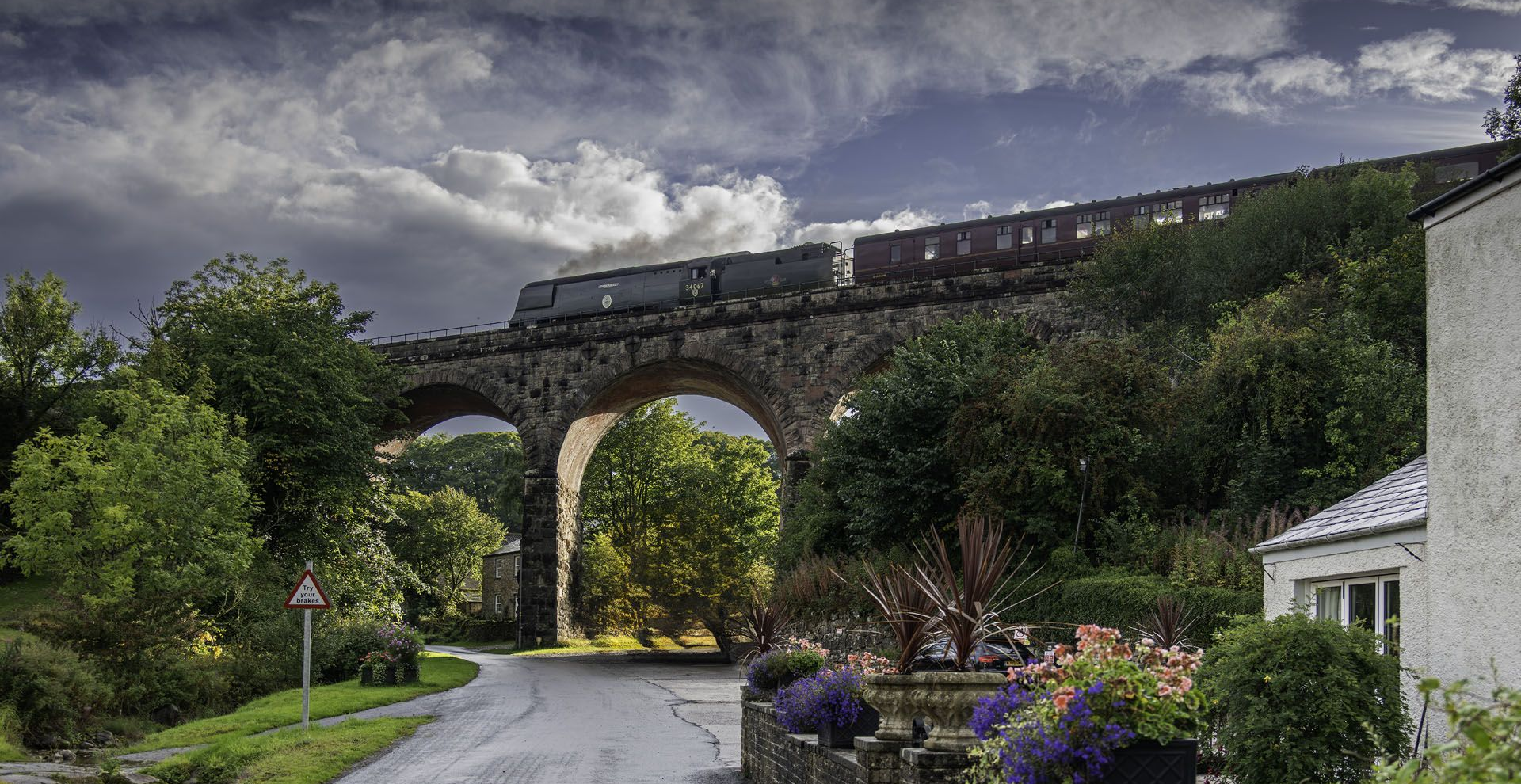 Lucerne, Switzerland, aerial view with river, wooden bridge, buildings, and setting sun.