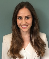 a portrait of Dr. Elena Putterman, Board-Certified Dermatologist wearing a white blouse