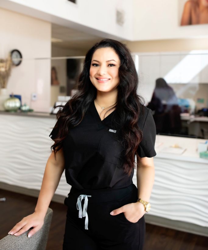 a portrait of Mercedes Alvarez, Esthetician wearing black scrubs