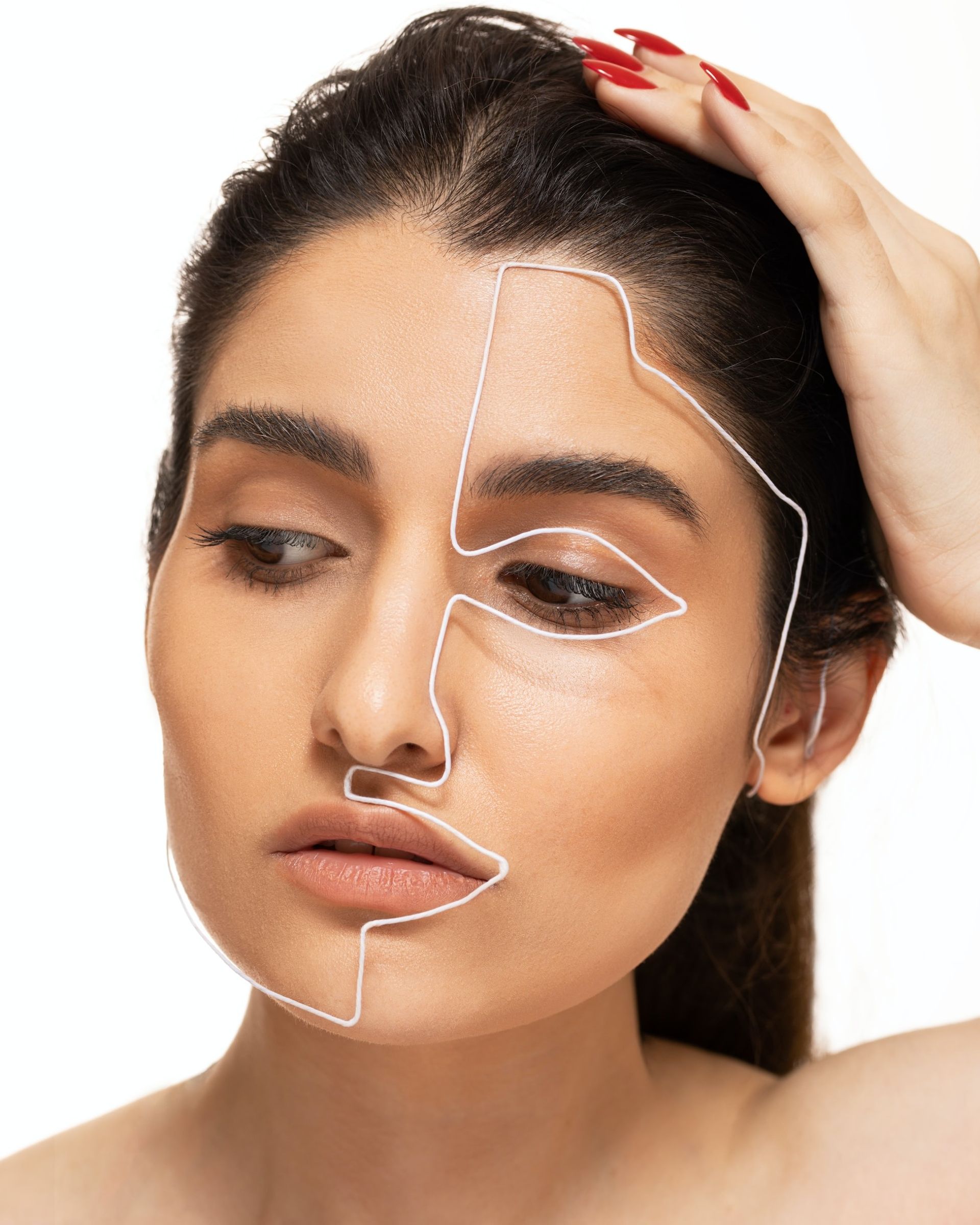 a woman with a wire outlining her right face.