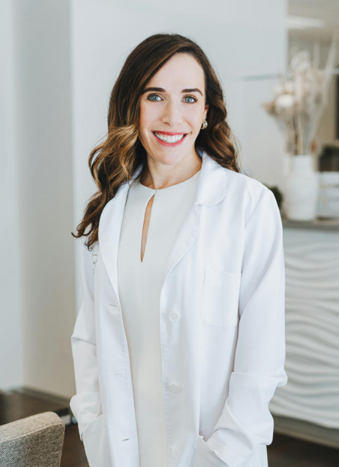 Dr. Jill Javahery in a white doctor's coat smiling at camera