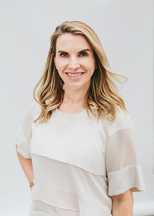 a portrait of Dr. Nancy Samolitis, Board-Certified Dermatologist wearing a white blouse