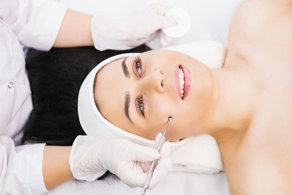 a woman is getting a facial treatment.