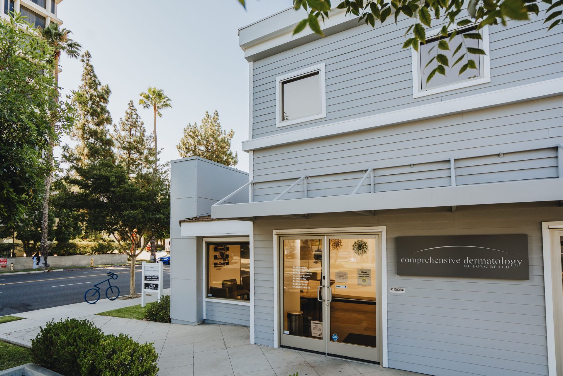 a building with a lot of windows and a bicycle parked in front of it