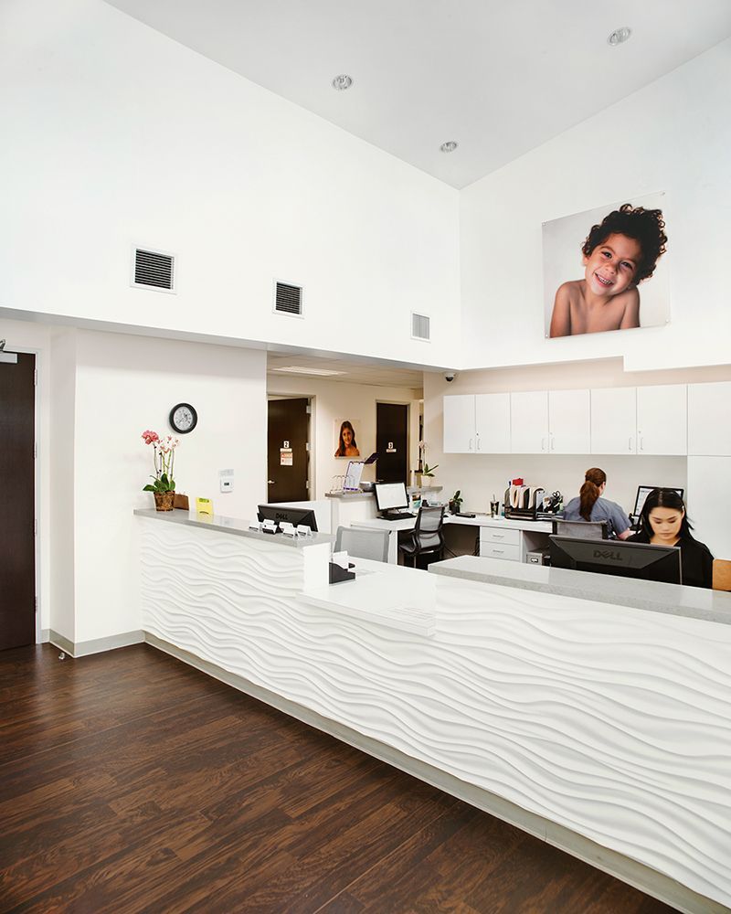 a reception area with a picture of a child on the wall above the counter