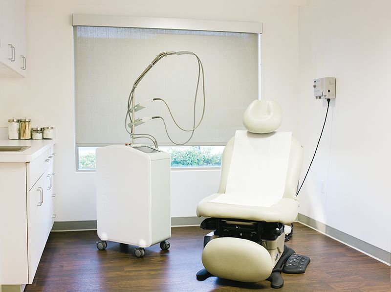 a doctor 's office with a chair and a window