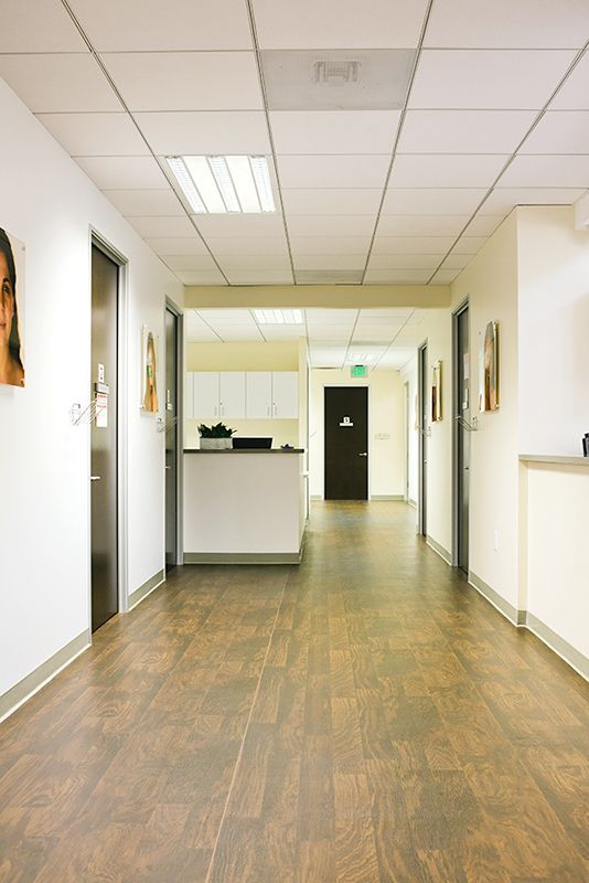 a long hallway with wooden floors and white walls