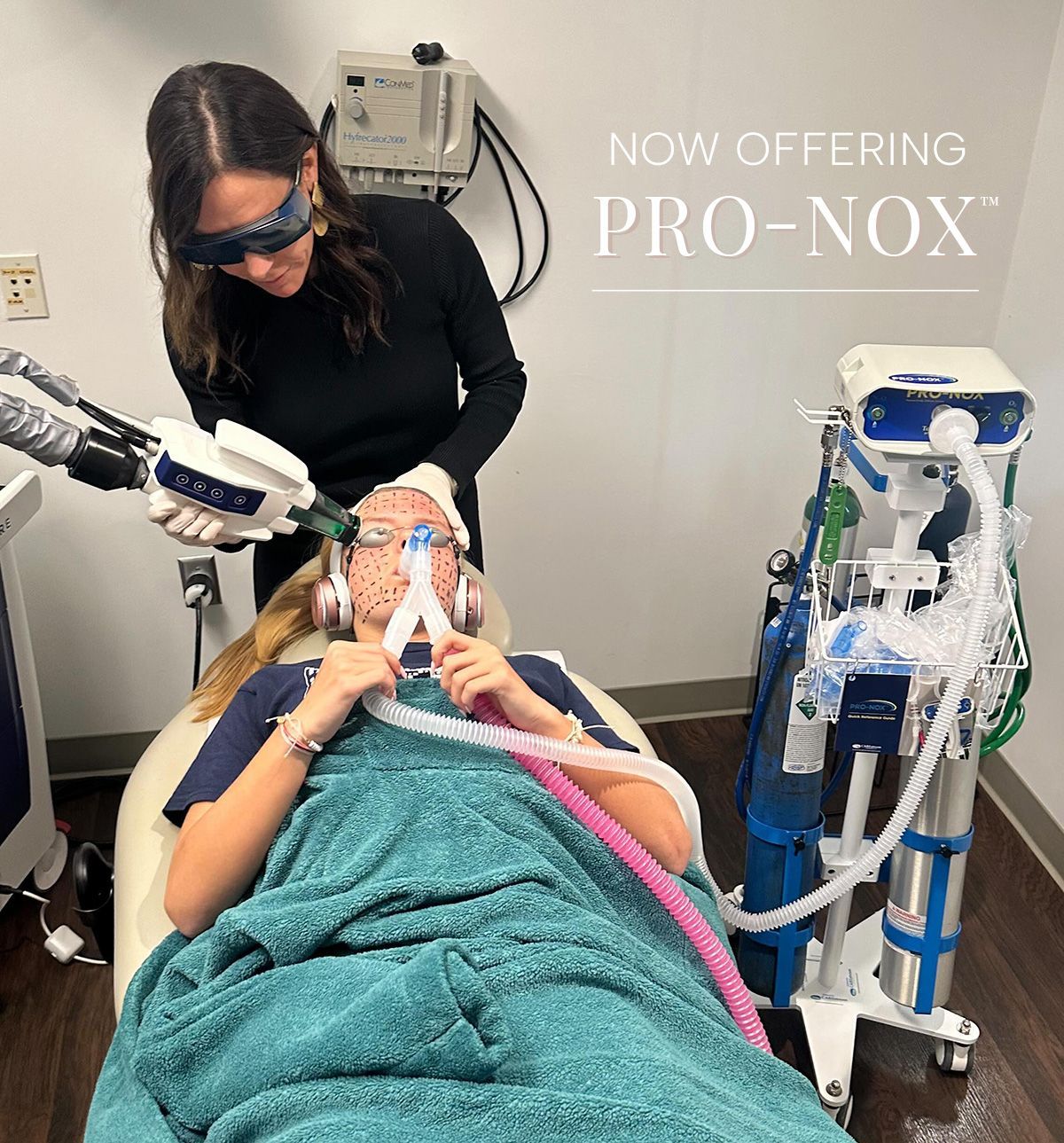 Dr. Jill Jahavery applies Accure laser treatment to patient while patient uses Pro-Nox nitrous oxide inhaler machine