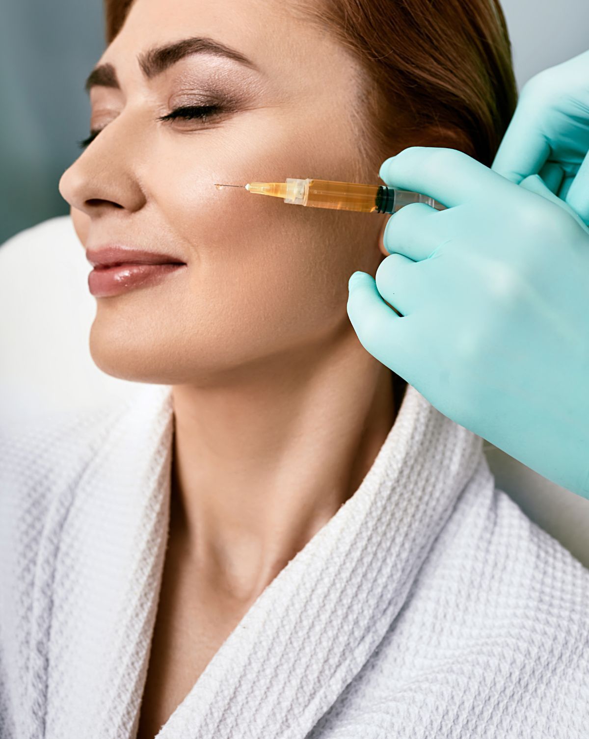 a woman is getting a prp injection in her face