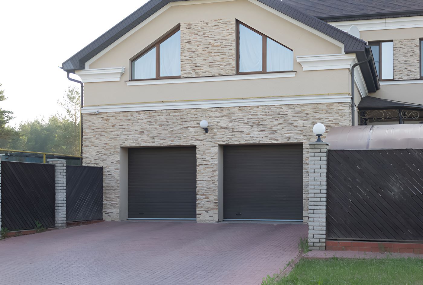 A Large House With Two Garage Doors and a Driveway — Prime Built Group in Bowral, NSW