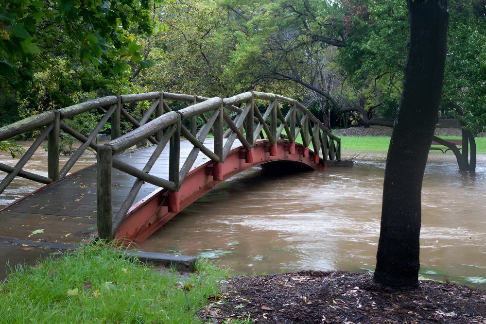 A Wooden Bridge Over a Flooded River in a Park — Prime Built in Mittagong, NSW