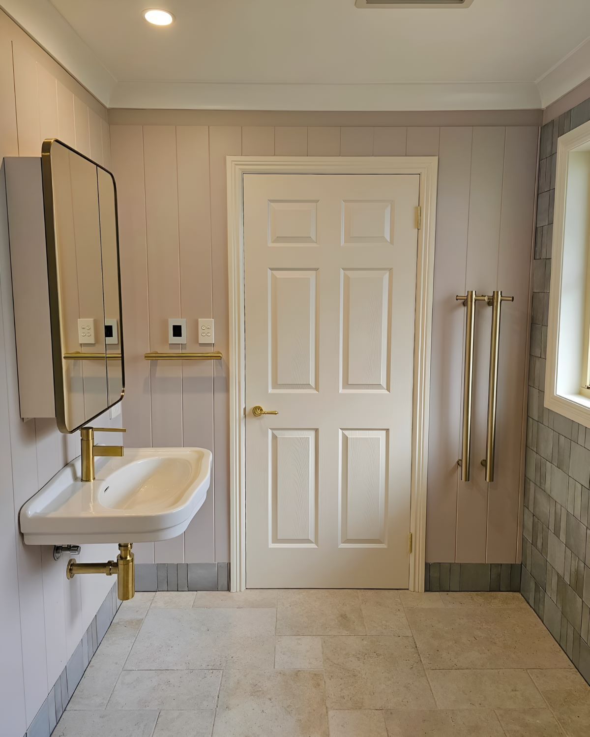 A Bathroom With a Sink a Mirror and a Door — Prime Built Group in Bowral, NSW