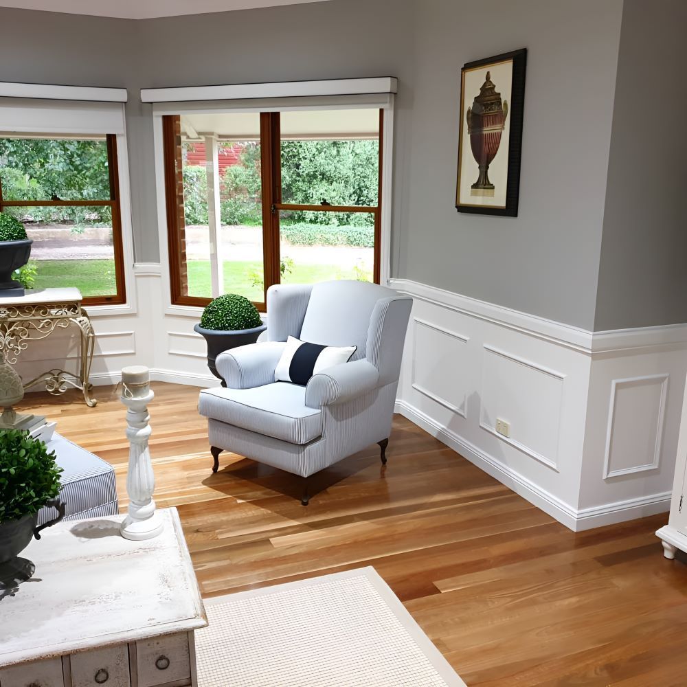 A Living Room With a White Chair and a Table — Prime Built Group in Bowral, NSW