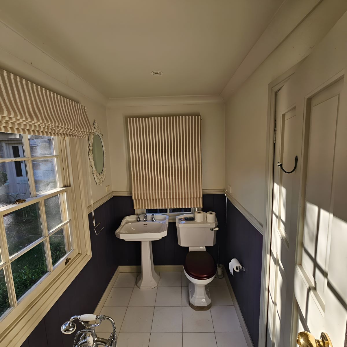A Bathroom With a Toilet a Sink and a Window — Prime Built Group in Bowral, NSW