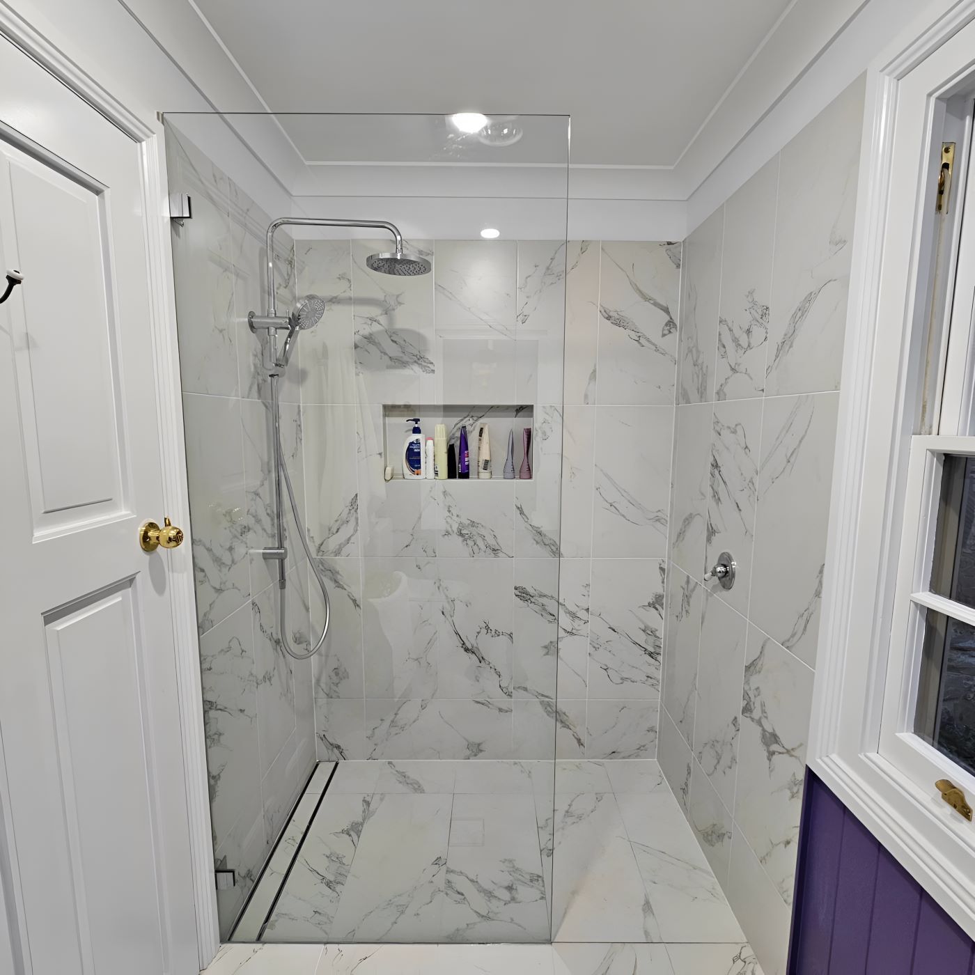 A Bathroom With Marble Tiles and a Walk in Shower — Prime Built Group in Bowral, NSW