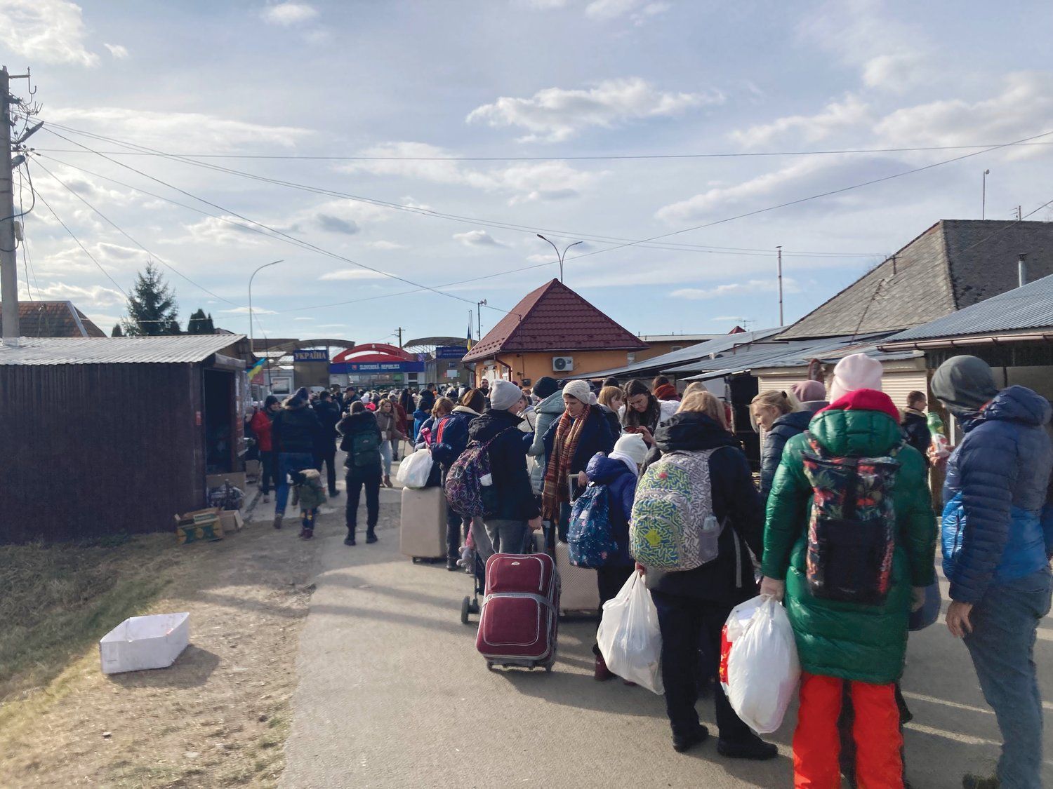 Ukrainians and other travelers wait at Slovak border to escape war.