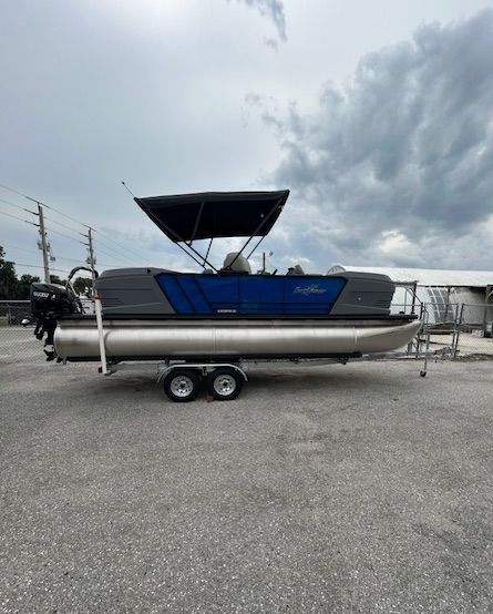 A man is washing a boat in a marina.