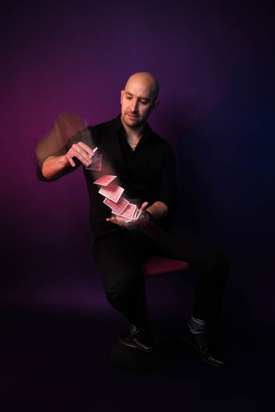 Victor Oriza performing a professional card flourish for a corporate event in Maryland.