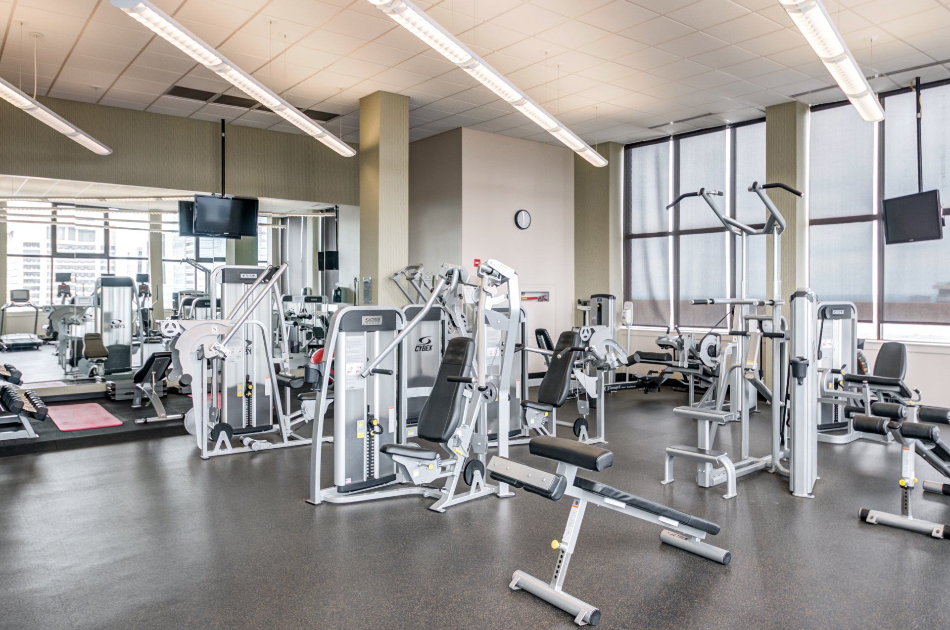 A large gym filled with lots of exercise equipment
